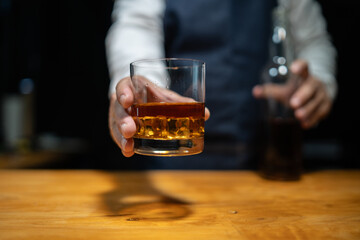 Barman pouring whiskey whiskey glass..