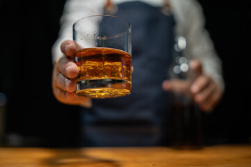 Barman pouring whiskey whiskey glass..