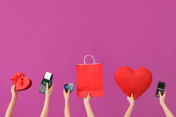 Women with gift, payment terminals, credit cards and shopping bag on purple background. Valentine's...