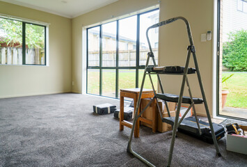 Empty home with ladder, tools and curtains on the floor. Home renovation project. Auckland.