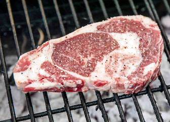 Marinated raw chop ready to be cooked on the grill