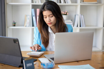 Business woman working in office with documents and laptop. Business concept