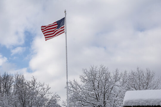American Flag Flies over Snowy Landscape