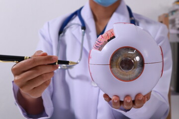 Close up of the ears of a professional female doctor in uniform taking notes in a notebook Medical therapist filling out medical documents. Clipboard. Patient form. Illness history, prescription