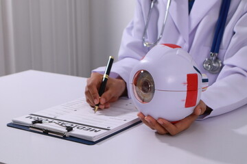 Close up of the ears of a professional female doctor in uniform taking notes in a notebook Medical...