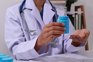 Close up of the ears of a professional female doctor in uniform taking notes in a notebook Medical therapist filling out medical documents. Clipboard. Patient form. Illness history, prescription