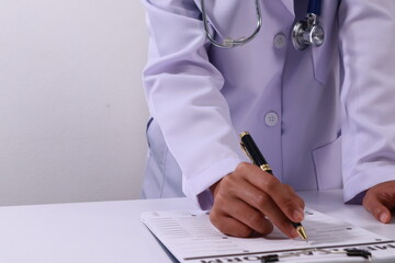 Close up of the ears of a professional female doctor in uniform taking notes in a notebook Medical...