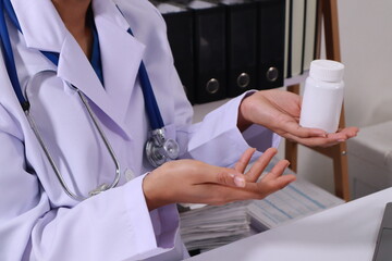 Close up of the ears of a professional female doctor in uniform taking notes in a notebook Medical...