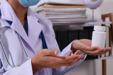 Close up of the ears of a professional female doctor in uniform taking notes in a notebook Medical...
