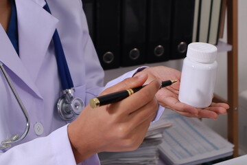 Close up of the ears of a professional female doctor in uniform taking notes in a notebook Medical...