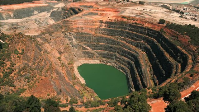 drone shot revealing an abandoned mine pit and a mining site in the background in western Australia