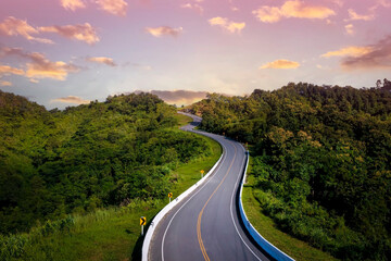 The sunset view with  highway stairs to the sky of road trough with green forest  as the nature...