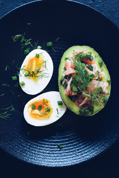 Healthy Breakfast With Eggs And Stuffed Avocado With Salmon