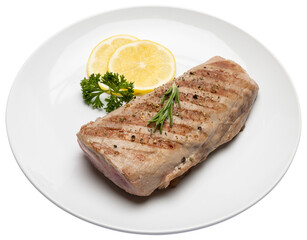 grilled cooked piece of tuna fillet on ceramic plate isolated