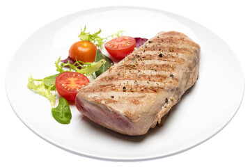 grilled cooked piece of tuna fillet on ceramic plate isolated