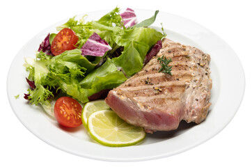 grilled cooked piece of tuna fillet on ceramic plate isolated
