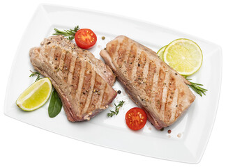 grilled cooked piece of tuna fillet on ceramic plate isolated