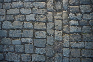 The texture of masonry on the street. Cobblestone, old elements in old cities
