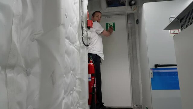 Captain demonstrate emergency exit escape route from ship`s engine room