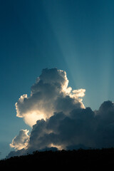 View of the clouds through which the rays of sunset light from the sun break through. Divine Light. Background image. Religion and self-knowledge.