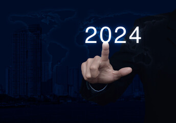 Businessman pressing 2024 letter over world map, modern city tower and skyscraper, Business happy new year 2024 cover concept, Elements of this image furnished by NASA