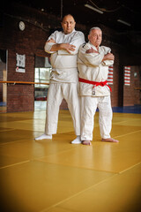 Two respected and experienced judo sensei master instructor in traditional gi kimono. A skilled...