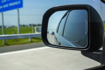 View of the toll road in the car's side mirror