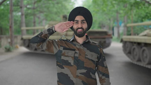 Happy Sikh Indian Army man saluting Indian flag