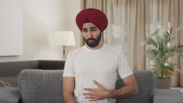 Sick Sikh Indian man suffering from acidity