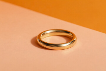 Gold ring on an orange pastel background