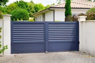 Fotobehang modern new grey gate of home aluminum portal suburb door in house © OceanProd