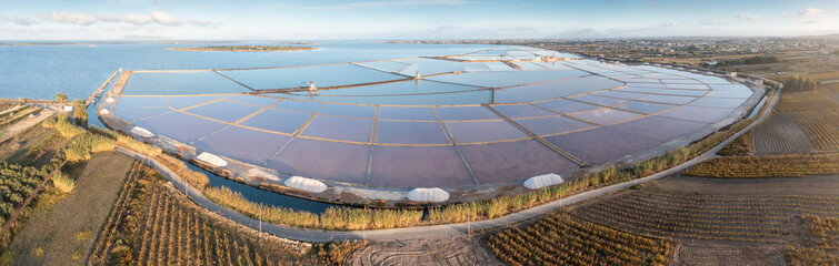 Natural reserve of the Saline dello Stagnone, near Marsala and Trapani, Sicily.,Aerial picture of Trapani salt evaporation ponds and salt mounds these ponds are filled from ocean and salt crystals are