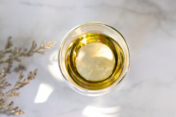 Glass cup of tea with warm sunlight in a garden.