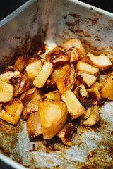 Crispy baked caramelised apple with cinnamon, sweet fillings for apple pie fresh off the oven contained in a rack. Close up shot for a cafe .