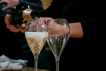 Tasting of sparkling wine champagne on winter weekend festival in December on Avenue de Champagne,...