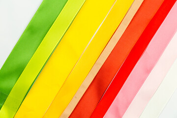 Rainbow ribbons. Flat lay. Multicolored tapes. Rainbow-colored adhesive tape. A set of bright sticky decorative ribbons for creativity, gift box packaging, making postcards. Materials for making craft