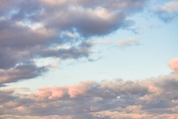 A beautiful sky tinted by the sun leaving vibrant shades of gold, pink, blue and multicolored. Clouds in the twilight evening and morning sky. Image of a cloudy sky in the evening and during the day. 