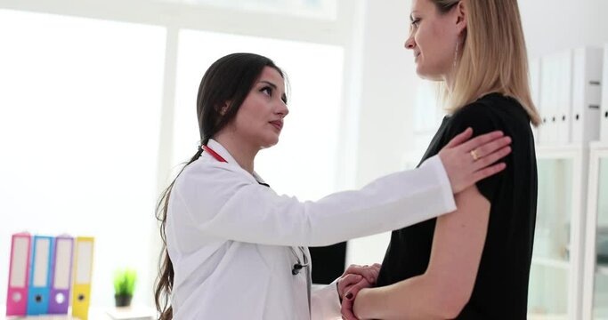 Doctor patting patient on shoulder and helping psychologically 4k movie slow motion