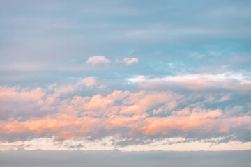 A beautiful sky tinted by the sun leaving vibrant shades of gold, pink, blue and multicolored. Clouds in the twilight evening and morning sky. Image of a cloudy sky in the evening and during the day. 