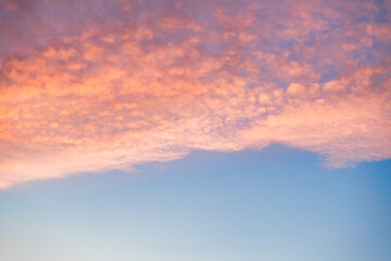 A beautiful sky tinted by the sun leaving vibrant shades of gold, pink, blue and multicolored. Clouds in the twilight evening and morning sky. Image of a cloudy sky in the evening and during the day. 