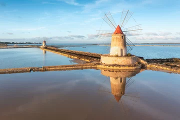 Foto op Canvas Sunset at Windmills in the salt evoporation pond in Marsala, Sicily island, Italy Trapani salt flats and old windmill in Sicily. View in beautifull sunny day. © Michal