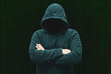 Mysterious faceless hooded anonymous computer hacker, silhouette of cybercriminal, terrorist