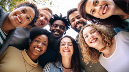Group of diverse, happy young adults posing together, smiling at the camera.