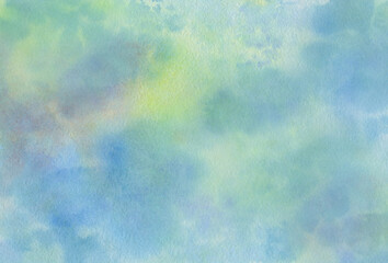 watercolor multi-colored background painted with a brush on paper, spots of blue, yellow and green colors