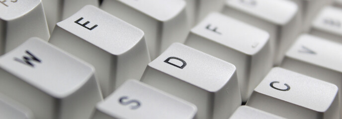 Closeup of typing keyboard with E D C alphabet focused.