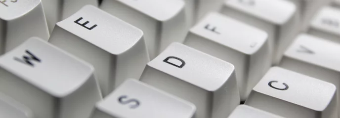 Fotobehang Closeup of typing keyboard with E D C alphabet focused. © ShivankB