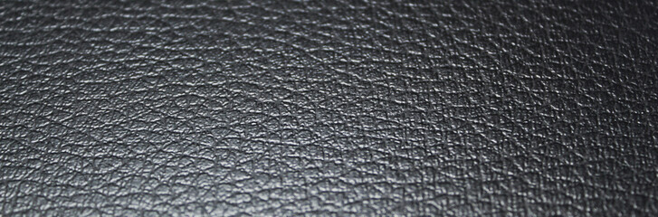 Black textured fake leather banner style background and copy space