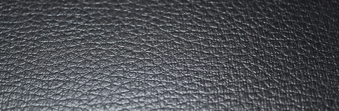 Black textured fake leather banner style background and copy space