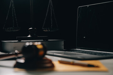 image of judge's hammer, scales lady of justice, law book, laptop computer and contract documents...