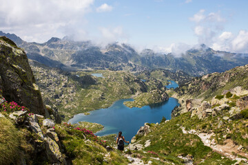 Young hiker girl summit to Ratera Peak in Aiguestortes and Sant Maurici National Park, Spain